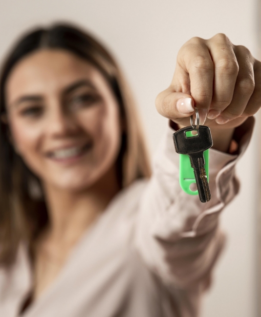 close up blurry woman holding keys